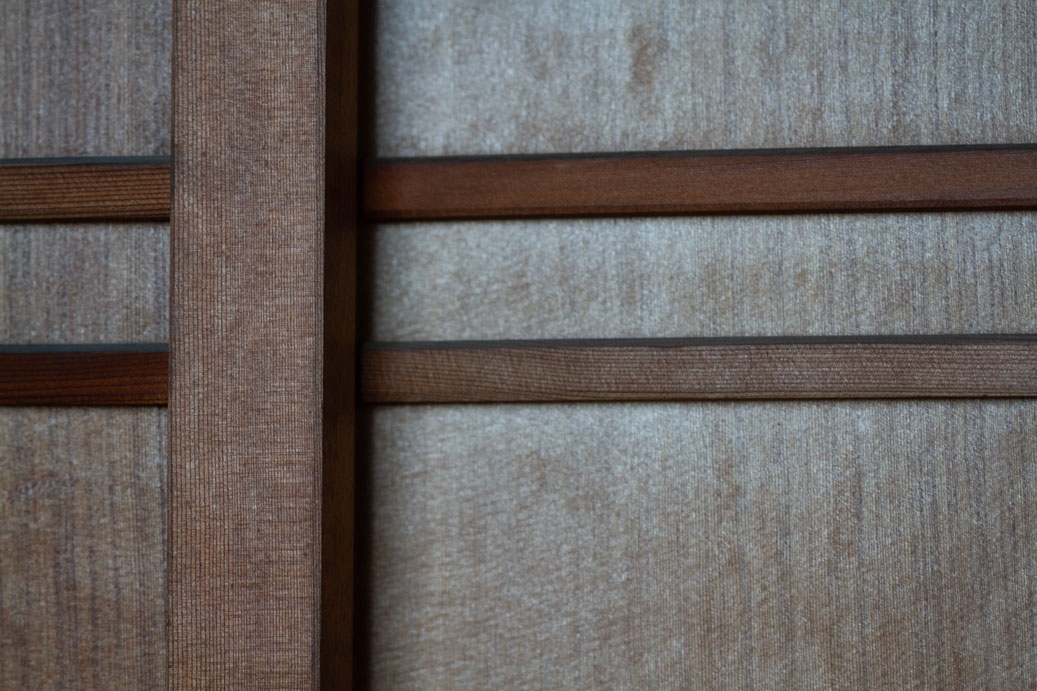 Close-up photograph of a Japanese-style wooden door